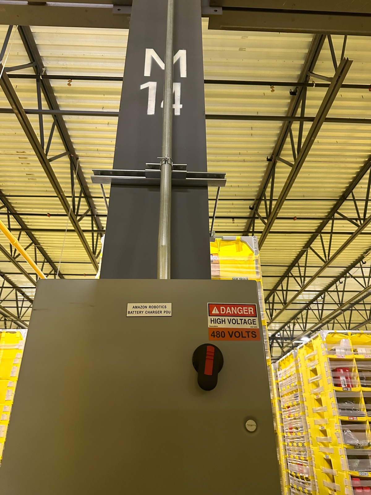 Finished 480V PDU enclosure with high-voltage danger placard mounted to a structural column